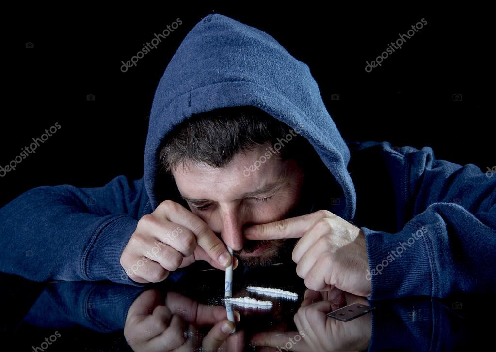 Sad man doing sniffing cocaine at home on his own — Stock Photo