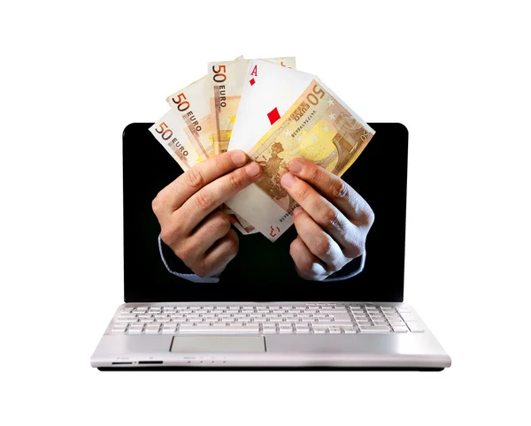 Man hands comming outlaptop holding euro banknotes and ace poker playing cards — Stock Photo, Image