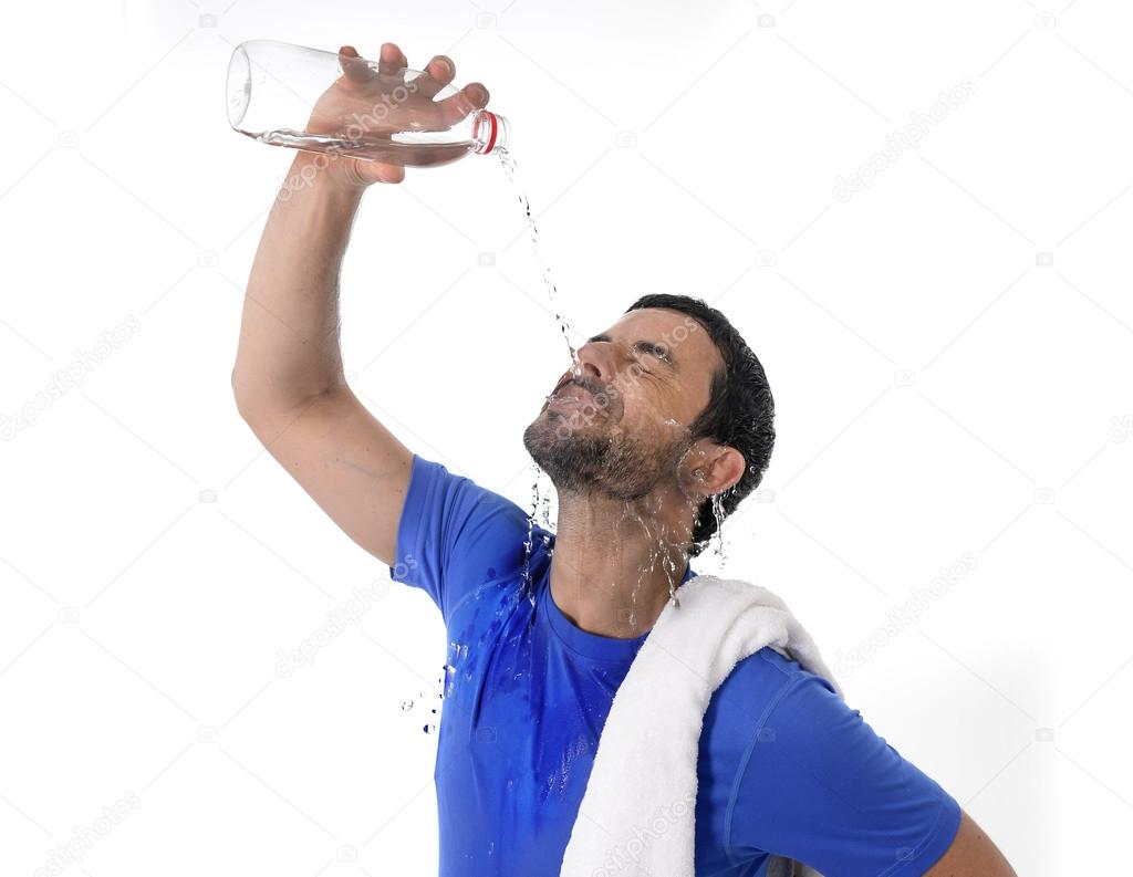 Young attractive and athletic sport man exhausted pouring water on his face