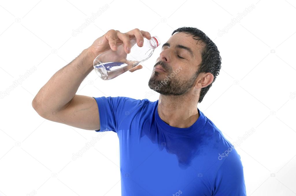 Young attractive and athletic sport man drinking water