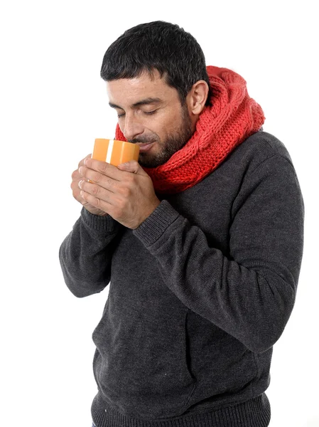 Attractive man drinking cup of coffee tea in winter warming his hands — Stock Photo, Image