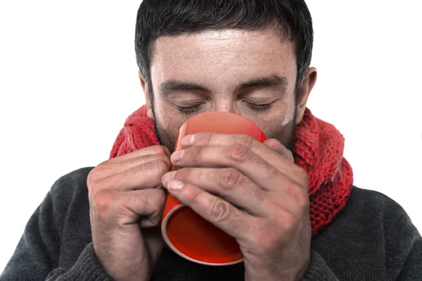 Attractive man drinking cup of coffee tea in winter warming his hands — Stock Photo, Image