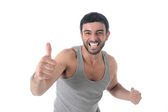smiling sport man with running shirt giving thumb up for fitness center add