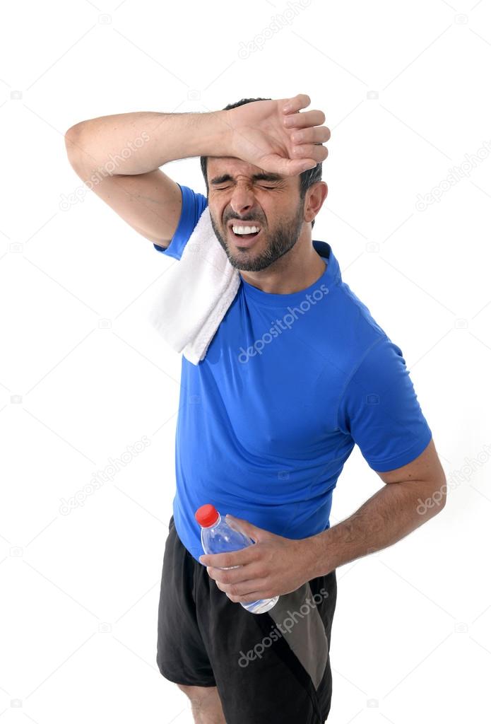 athletic sport man  holding water bottle wiping out sweat after 