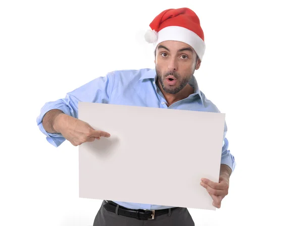 Hombre de negocios guapo en sombrero de navidad de santa señalando cartelera en blanco —  Fotos de Stock