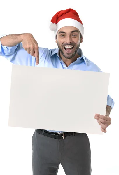 Bello uomo d'affari in cappello di Babbo Natale puntando cartellone bianco — Foto Stock