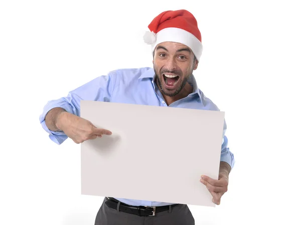 Hombre de negocios guapo en sombrero de navidad de santa señalando cartelera en blanco —  Fotos de Stock