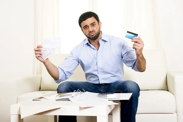 Latin business man worried paying bills on couch — Stock Photo, Image