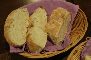 Kafenin restoranındaki masada sepette ekmek var. Ekmek sepeti. Taze hamur işleri.