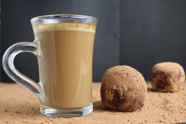 chocolate cake potatoes with coffee cappuccino on cocoa on a black background. Chocolate coffee dessert.