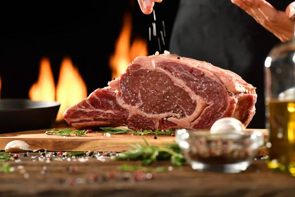 Hand Sprinkling Salt Seasoning Raw Ribeye Steak Meat Beef Wooden — Stock Photo, Image