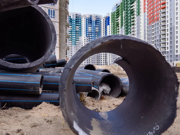 View Huge Black Pipe Building Site New Colorful High Rise — Zdjęcie stockowe