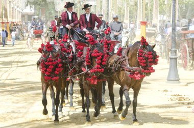 JEREZ DE LA FRONTERA, SPAIN-MAY 11: People mounted on a carriage clipart