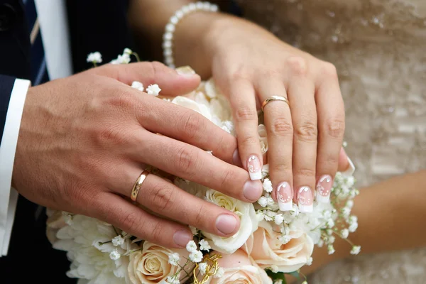 Hand brudgummen och bruden med vigselringar — Stockfoto