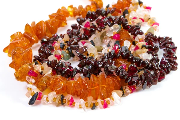 Beads of different stones on a white background — Stock Photo, Image