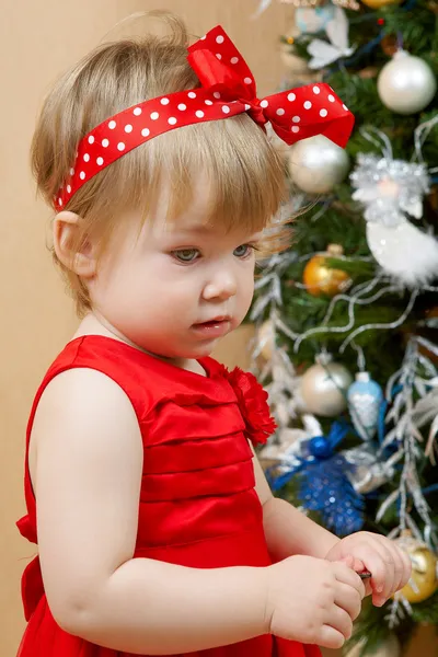 Cute thoughtful girl in red dress — Stock Photo, Image