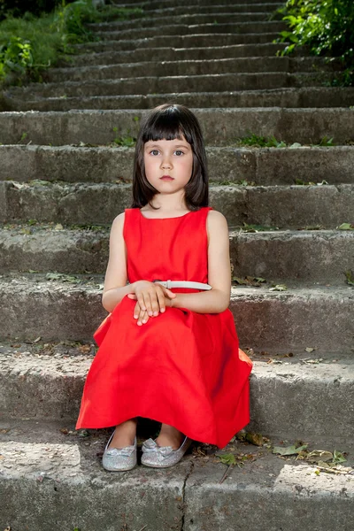 Charming little girl in a red dress — Stock Photo, Image