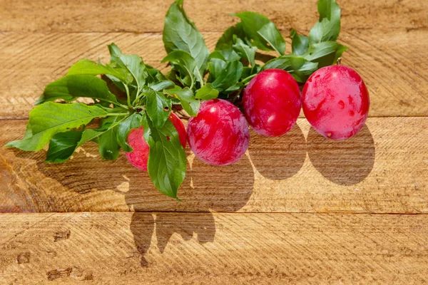 Fresh plums on  wooden table — Stock Photo, Image