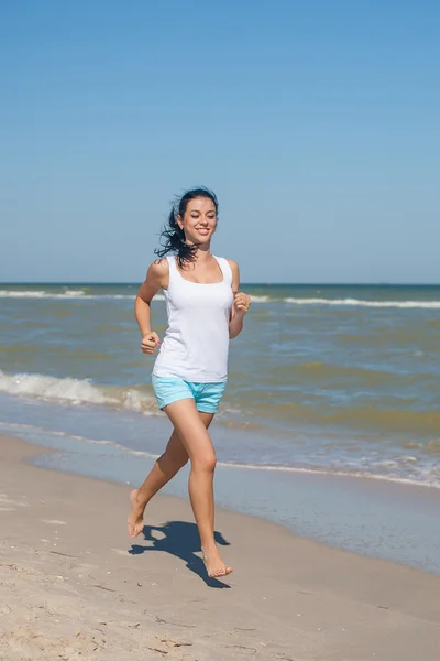 Молодая девушка бежит по морю — стоковое фото