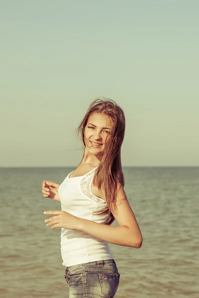 Young cheerful girl on the sea Stock Picture