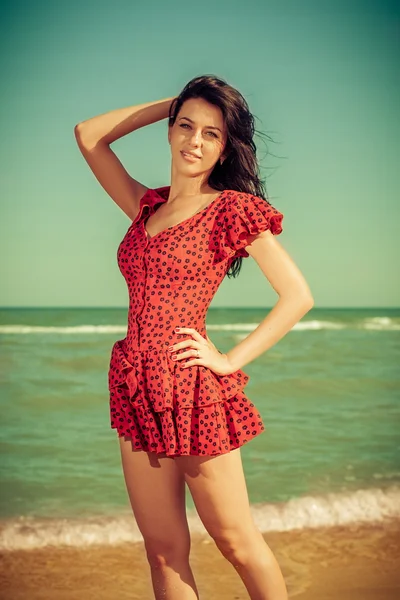 Young girl in red dress on the sea — Stock Photo, Image