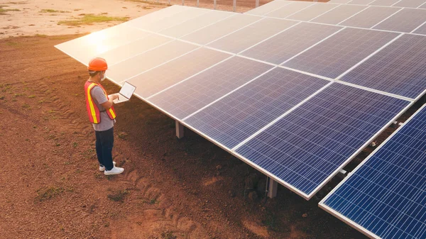 Technician checking the panel in solar power station panels,Renewable ecological source of energy from the sun