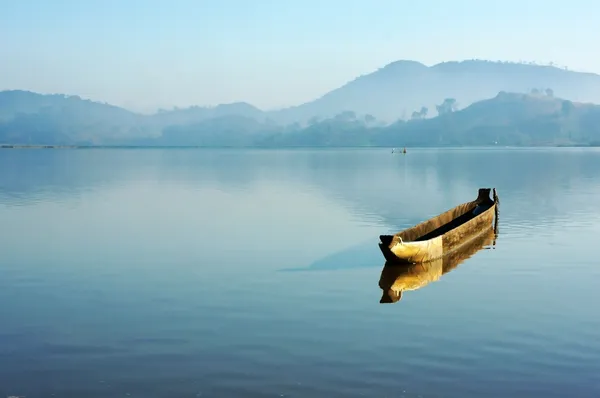 Charming landscape with lonely wooden boat (dug-out canoe ) on l — Stock Photo, Image