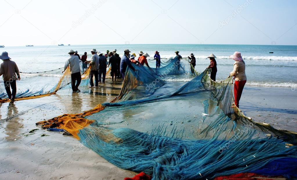 Group of fisherman pull fish net