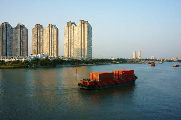 Maritime transport by loading container on river — Stock Photo, Image