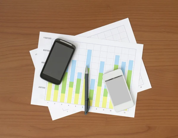 Two Phones & Two Charts on the Table — Stock Photo, Image