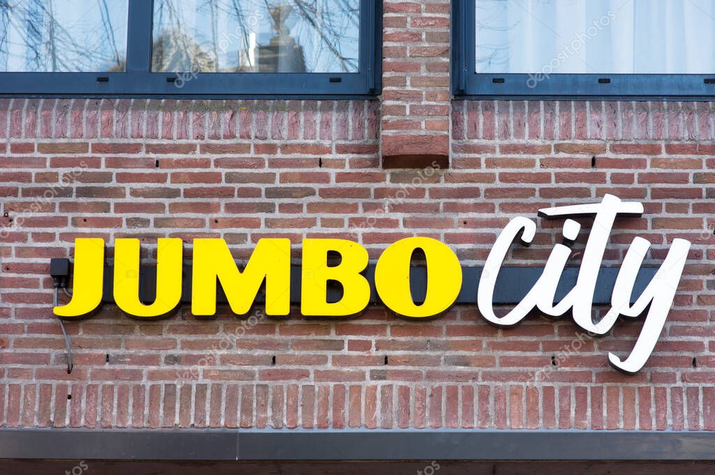 's-Hertogenbosch, Netherlands - February 12, 2022: Logo of Jumbo city supermarket store on the facade of the building in shopping street