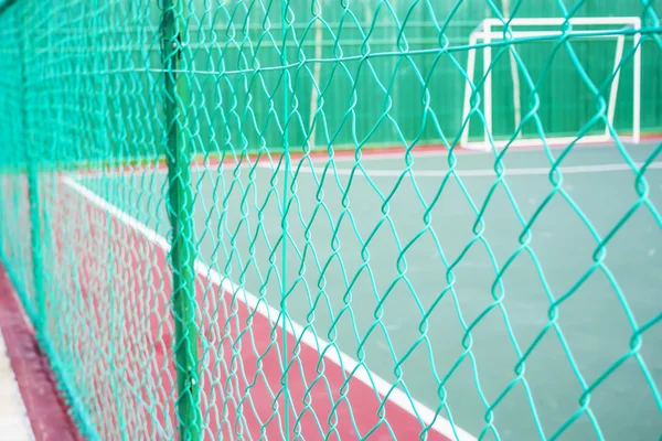 Clôture de maillon de chaîne de couleur verte entourant la cour futsal . — Photo