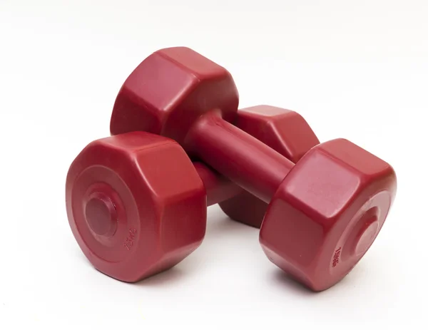 Close-up van geïsoleerde rood fitness halters. Rechtenvrije Stockfoto's
