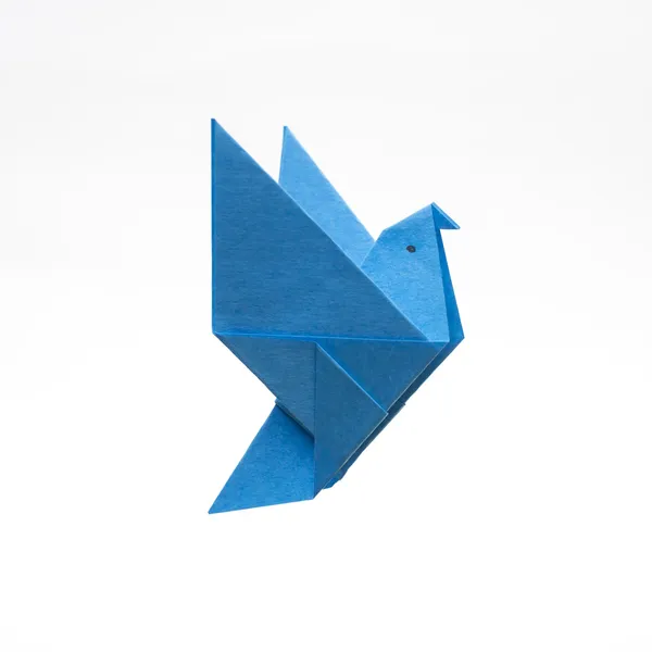 Forma de pájaro azul origami Imagen de archivo
