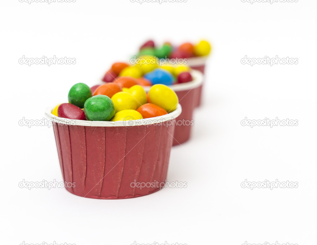 Isolated colorful candy in paper cup - selective focus