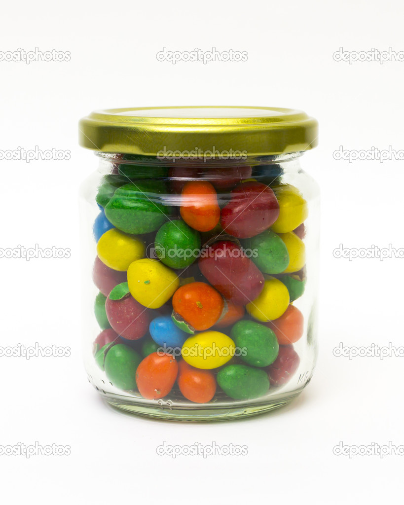 Isolated colorful candy in closed jar on white background.