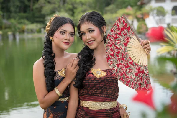 Two Young Bali Smiling Girls Make Dressed Traditional Colored Costumes — Stock Fotó