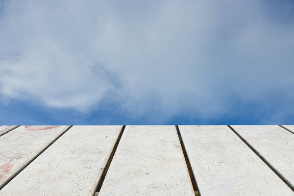 Blue sky and white clouds for background. wooden floor foreground
