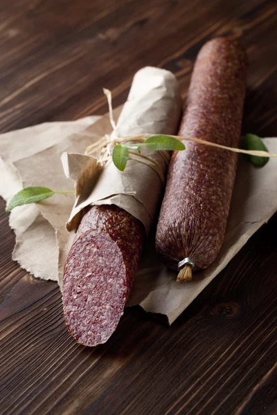 Salami on wooden and paper — Stock Photo, Image