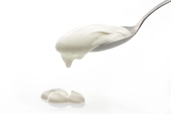 Cream in spoon isolated — Stock Photo, Image