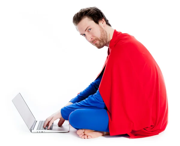 Attractive caucasian man wearing Superman clothes working on laptop — Stock Photo, Image