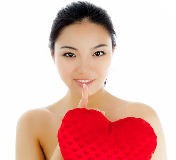 Attractive asian girl holding a big red heart — Stock Photo, Image