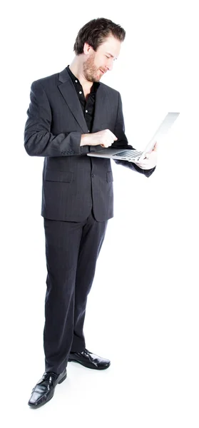 Attractive caucasian businessman working on a laptop — Stock Photo, Image