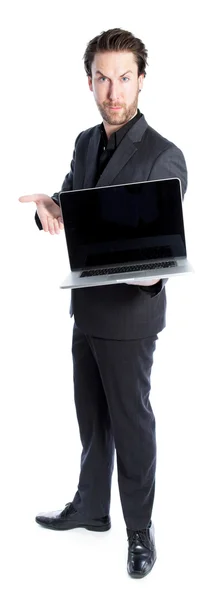 Attractive caucasian businessman shows on laptop — Stock Photo, Image
