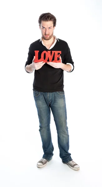 Attractive caucasian man holding a sign Love — Stock Photo, Image