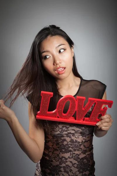 Girl holding LOVE sign — Stock Photo, Image