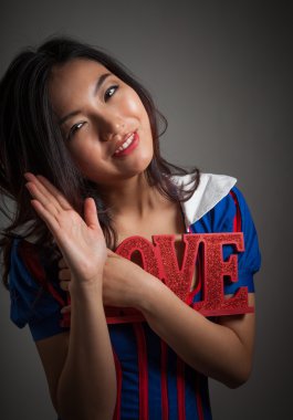 Romantic asian girl holding LOVE sign clipart