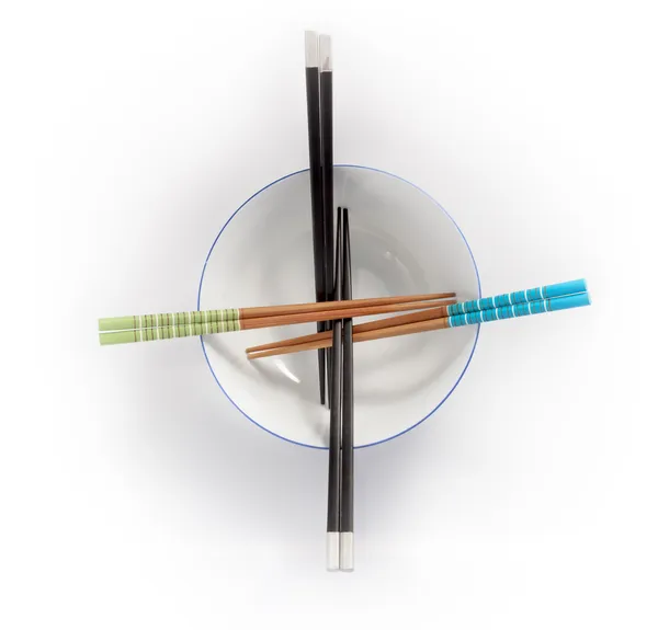 Chopsticks in empty bowl isolated on a white background — Stock Photo, Image