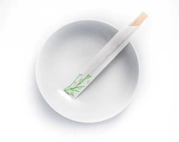 Disposable chopsticks in empty bowl isolated on a white backgrou — Stock Photo, Image