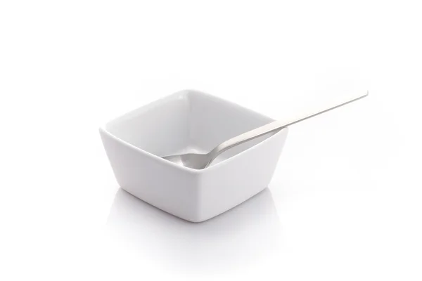 Spoon in a square bowl — Stock Photo, Image